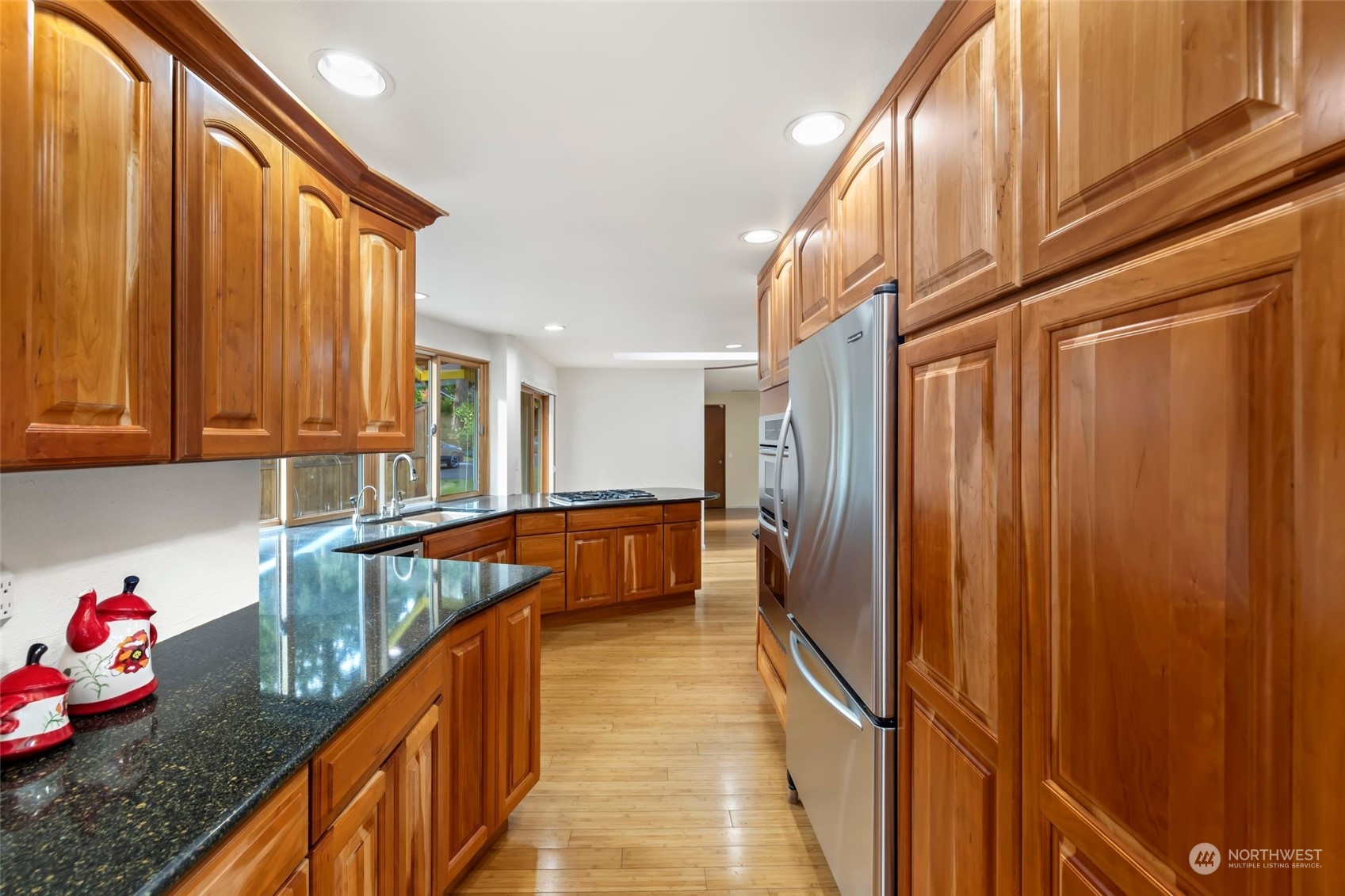12730 Southeast 95th Place Renton, WA 98056 - Photo 10 of 38 a kitchen with stainless steel appliances granite countertop a refrigerator and a sink
