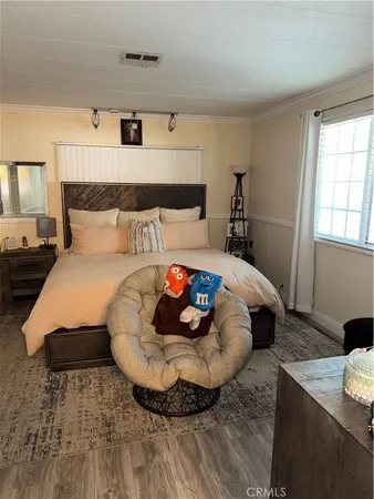 a bed sitting in a bedroom next to a window