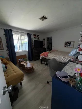 a bedroom with furniture and a window