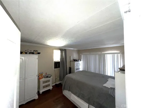a spacious bedroom with a bed and a window
