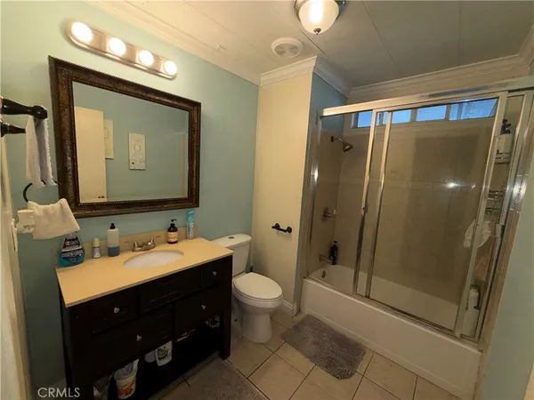 a bathroom with a double vanity sink mirror and toilet
