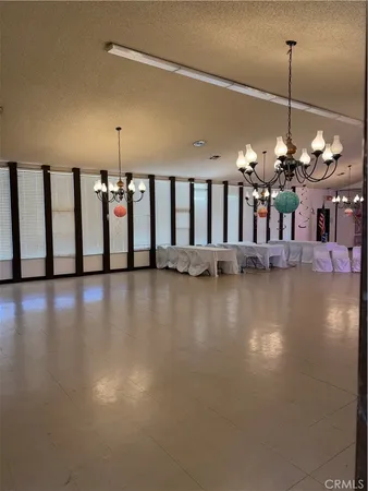a view of a living room and chandelier in hallway