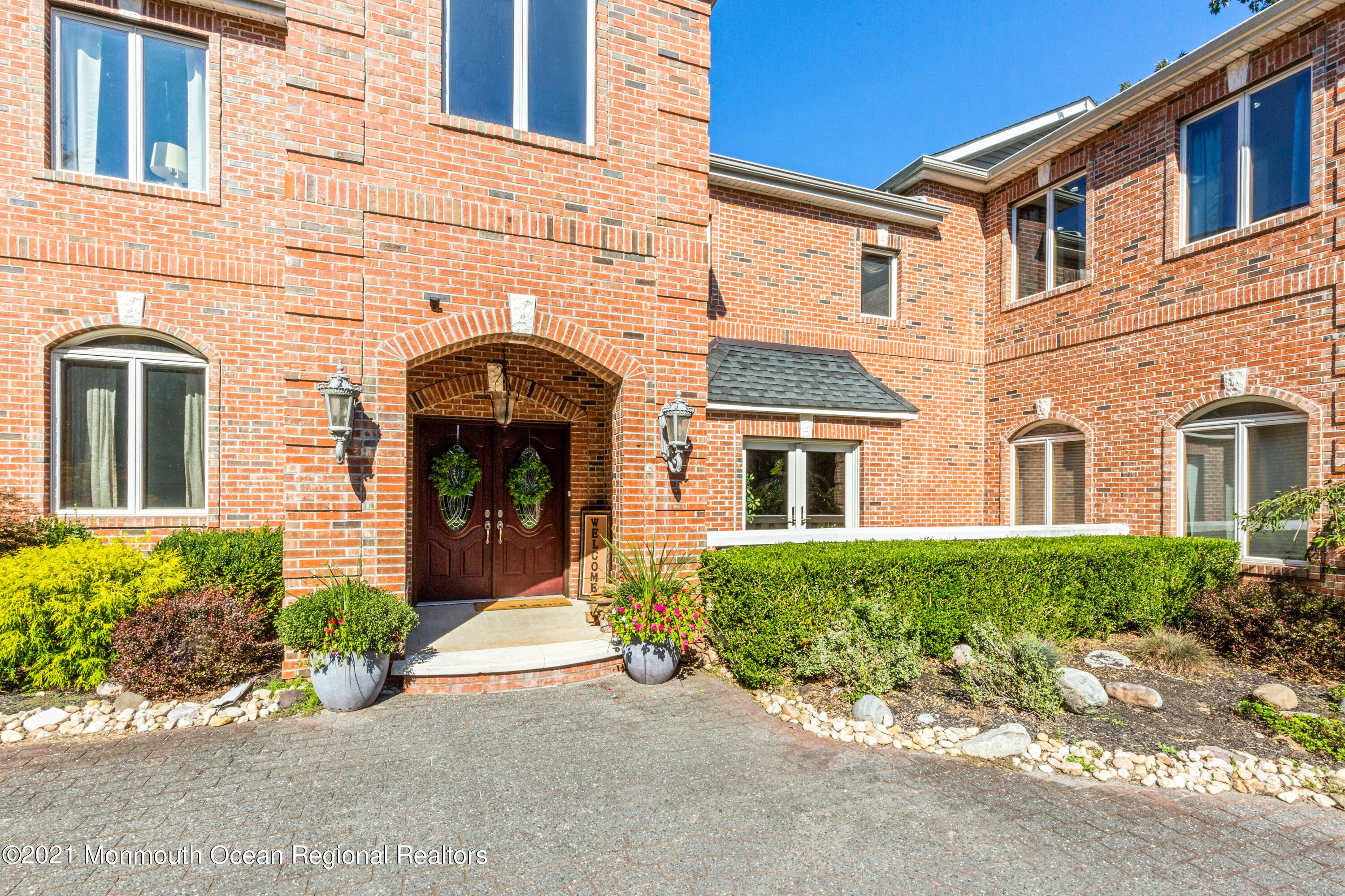 363 Lanes Pond Road Howell, NJ 07731 - Photo 4 of 72 front view of a brick house with potted plants