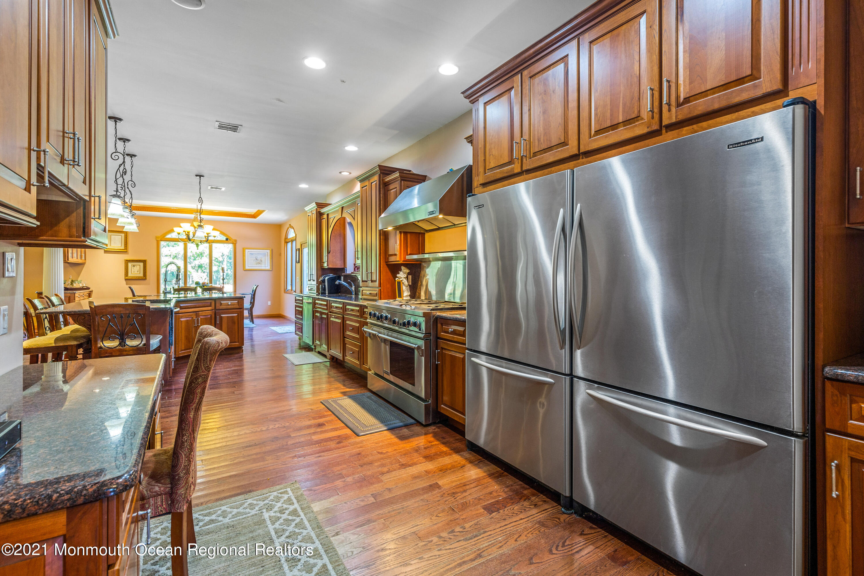 363 Lanes Pond Road Howell, NJ 07731 - Photo 8 of 72 a kitchen with stainless steel appliances granite countertop a refrigerator a stove a sink dishwasher and a dining table with wooden floor