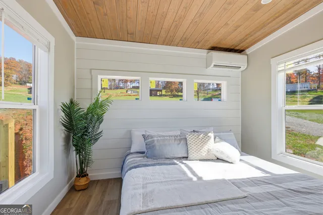 a bed sitting in a bedroom next to a window