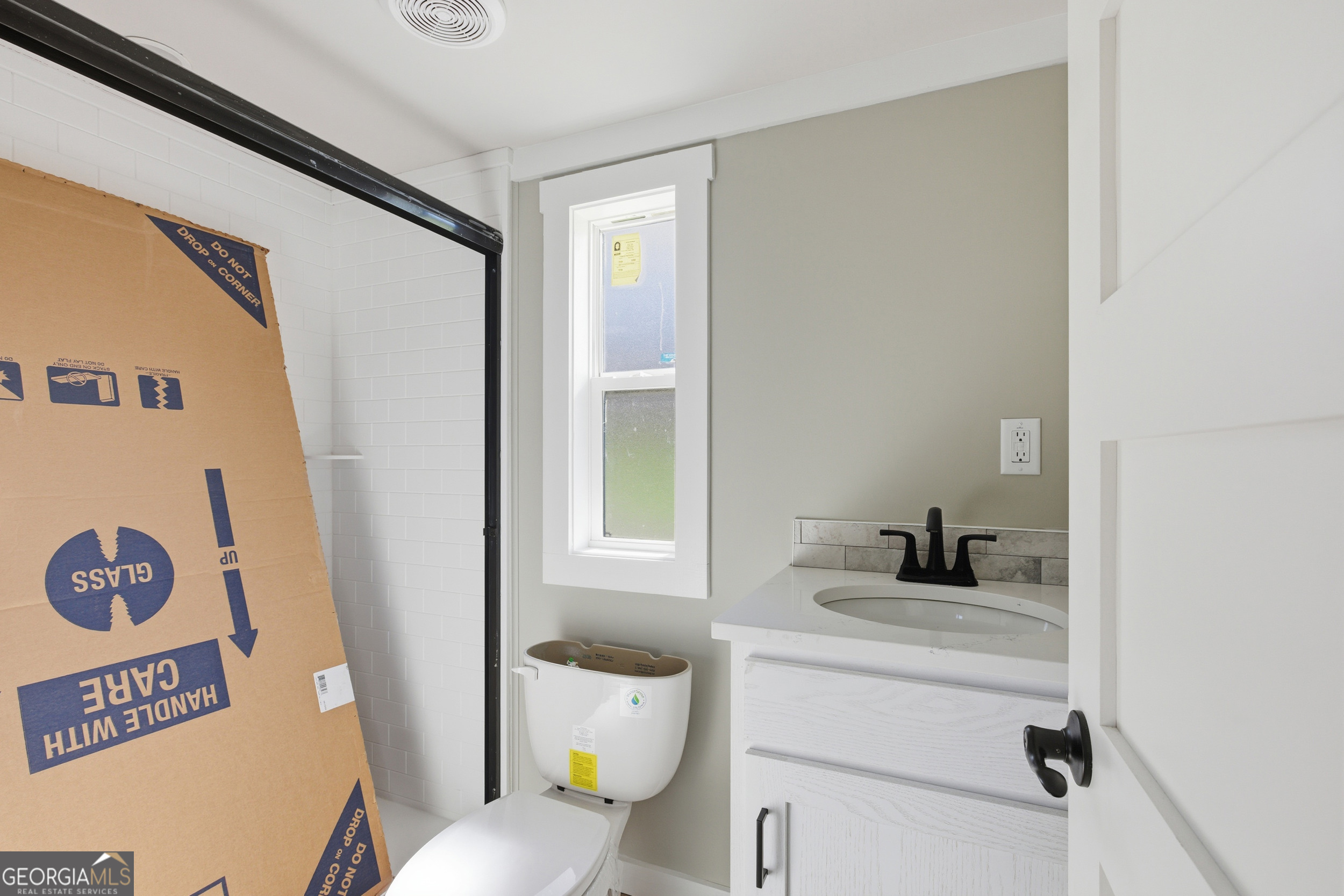 527 Saunders Road Franklin, NC 28734 - Photo 15 of 20 a bathroom with a sink toilet vanity and window