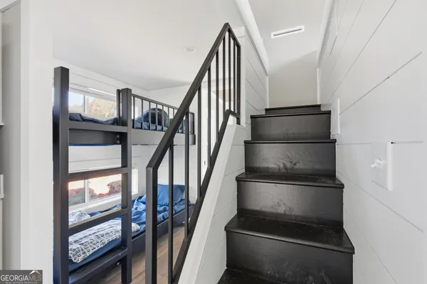 a view of staircase with lots of frames and frames on wall