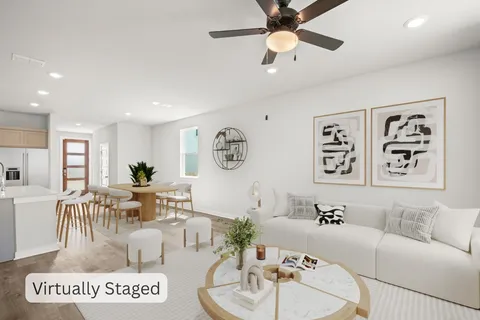 a living room with furniture and a wooden floor