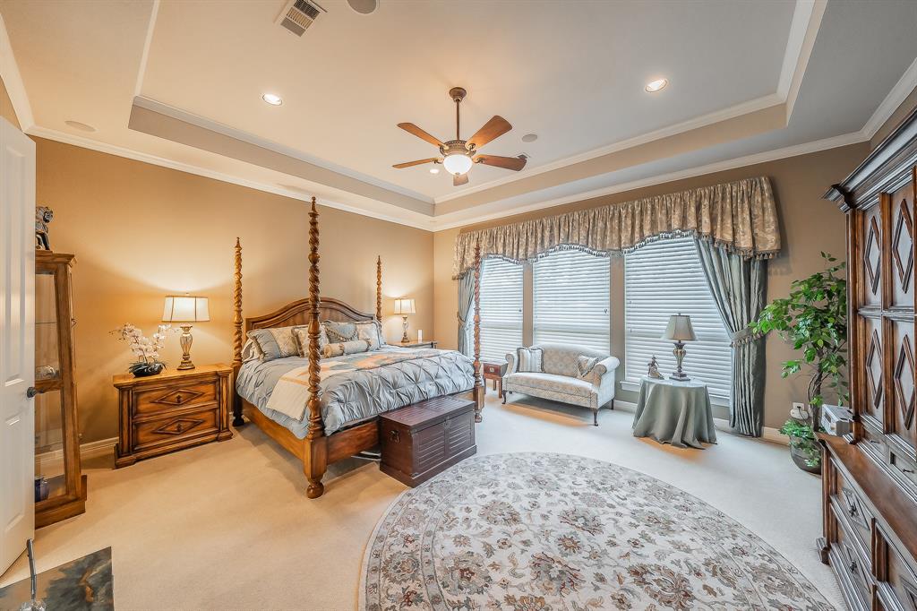 2726 Country Club Road Pantego, TX 76013 - Photo 15 of 26 a bedroom with a bed a large window and chandelier
