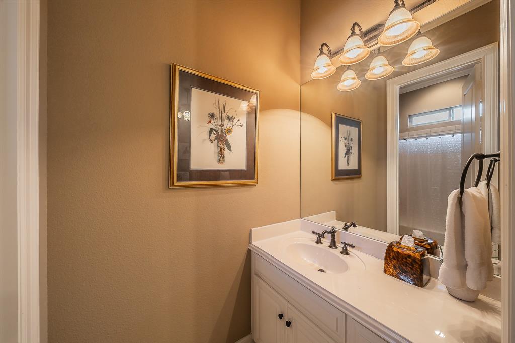 2726 Country Club Road Pantego, TX 76013 - Photo 19 of 26 a bathroom with a sink and mirror