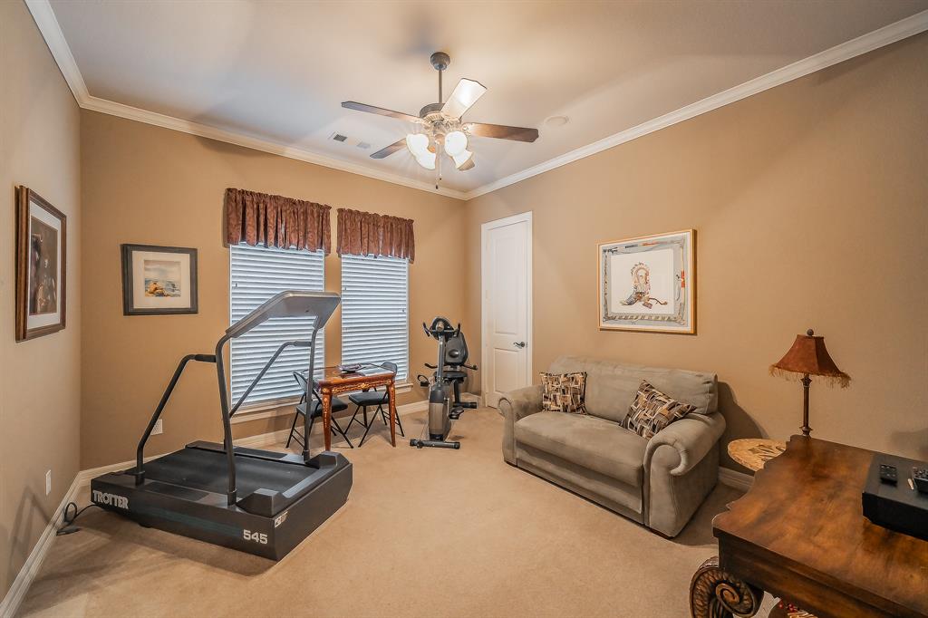 2726 Country Club Road Pantego, TX 76013 - Photo 20 of 26 a living room with furniture gym equipment and a window