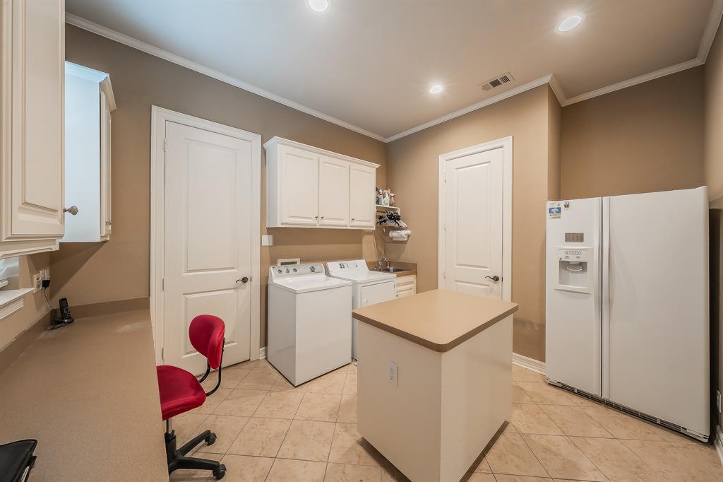 2726 Country Club Road Pantego, TX 76013 - Photo 21 of 26 a kitchen with a refrigerator and cabinets