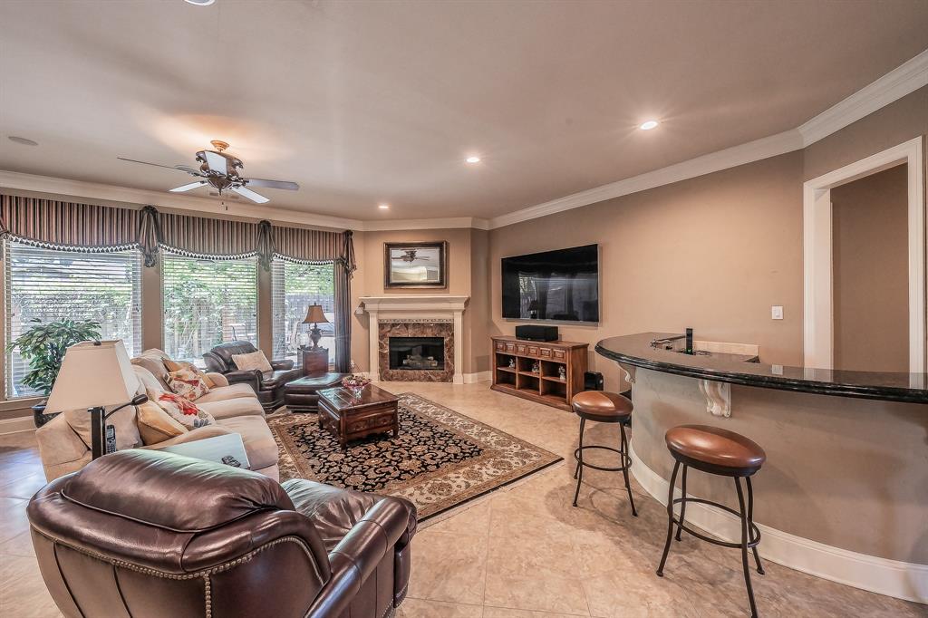 2726 Country Club Road Pantego, TX 76013 - Photo 8 of 26 a living room with furniture a fireplace and a flat screen tv