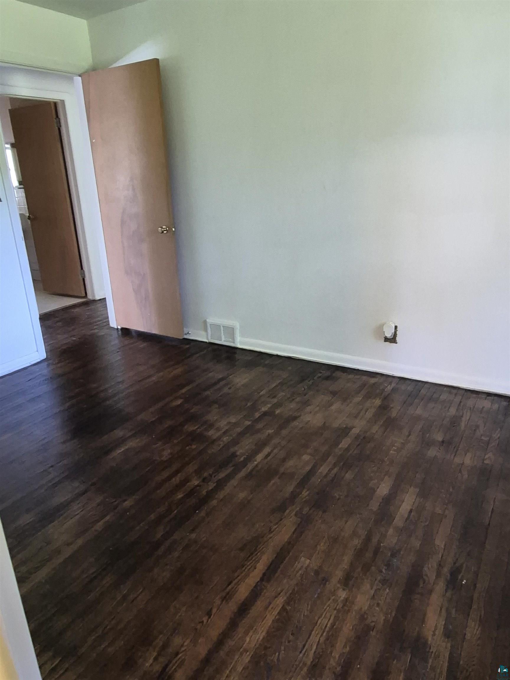 2109 West 22nd Street Duluth, MN 55811 - Photo 16 of 29 Dark wood-finish flooring with white walls and a light-colored interior door