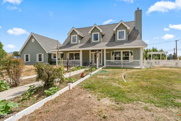 an aerial view of a house with outdoor space and lake view