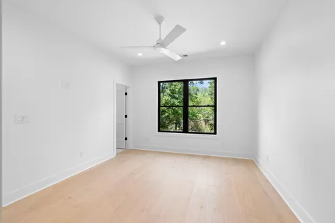 a living room with couches and a dining table with garden view