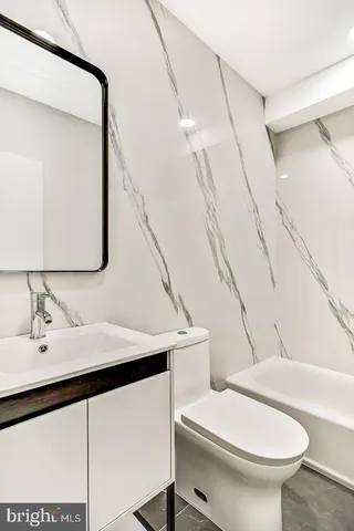 a view of a room with wooden floor and white walls