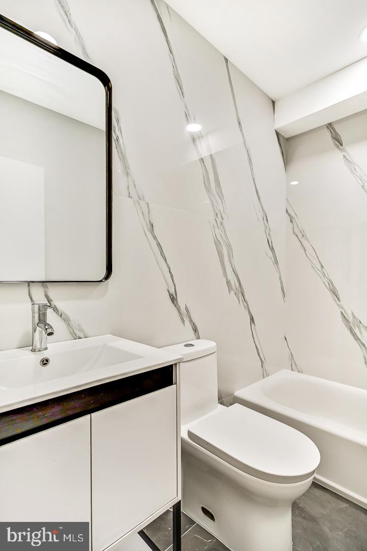 182 East Huntingdon Street Philadelphia, PA 19125 - Photo 12 of 41 a bathroom with a sink a toilet and mirror