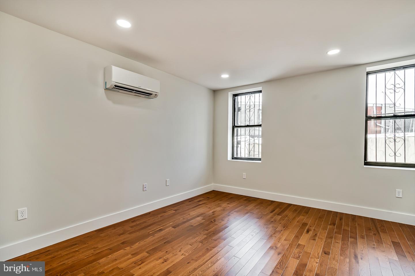 182 East Huntingdon Street Philadelphia, PA 19125 - Photo 16 of 41 an empty room with wooden floor and windows
