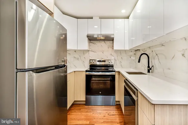 a kitchen with a sink a stove and cabinets