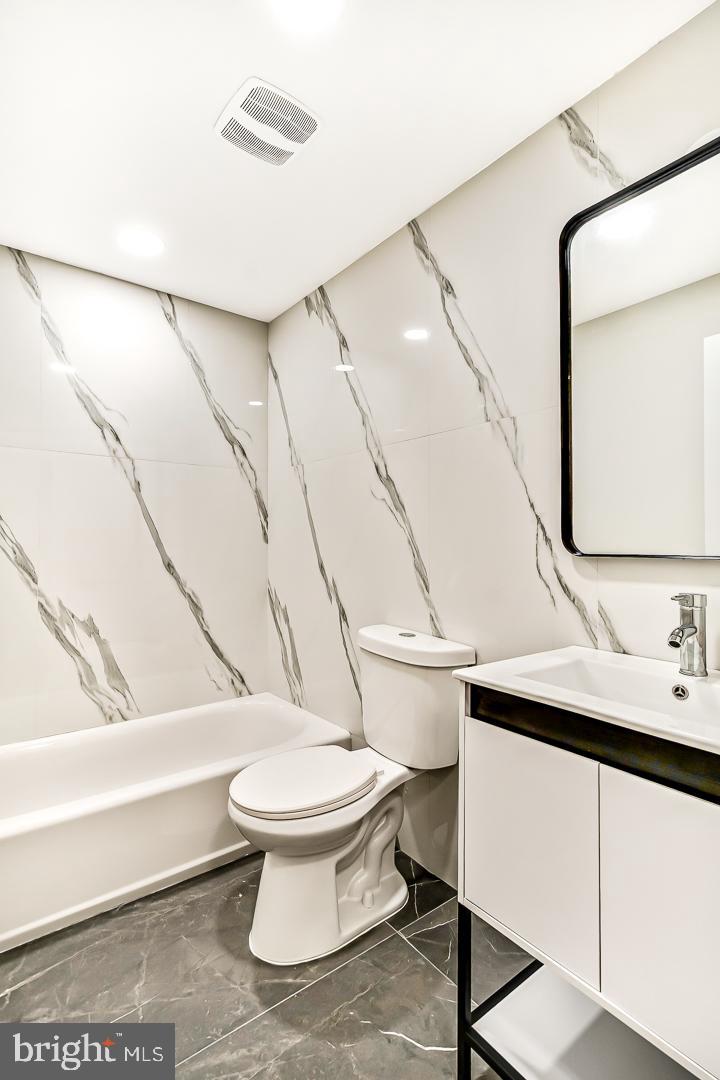 182 East Huntingdon Street Philadelphia, PA 19125 - Photo 21 of 41 a bathroom with a sink a toilet and a mirror