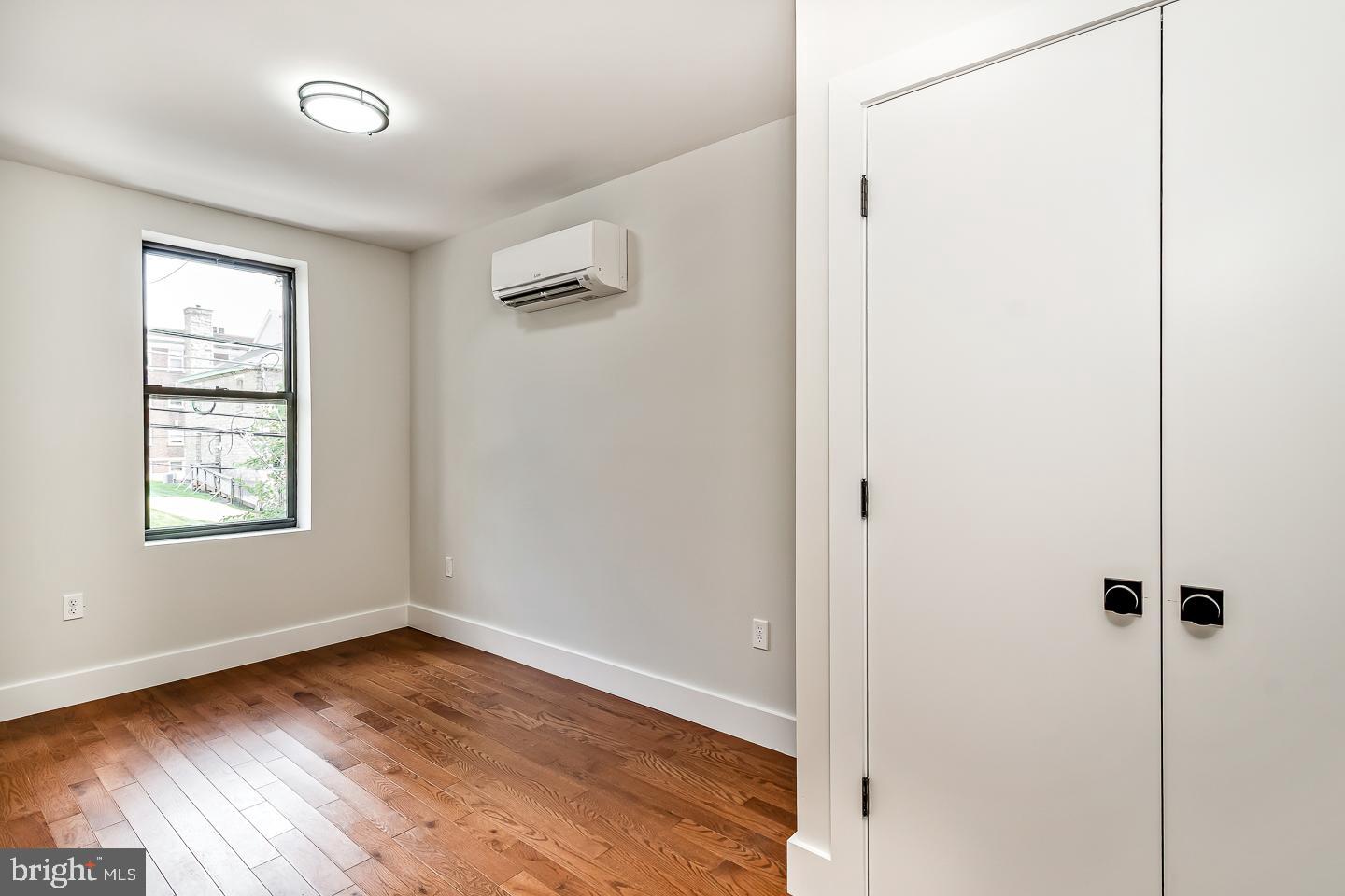 182 East Huntingdon Street Philadelphia, PA 19125 - Photo 24 of 41 a view of an empty room with wooden floor and a window