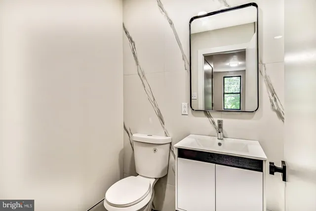 a bathroom with a sink a mirror and vanity