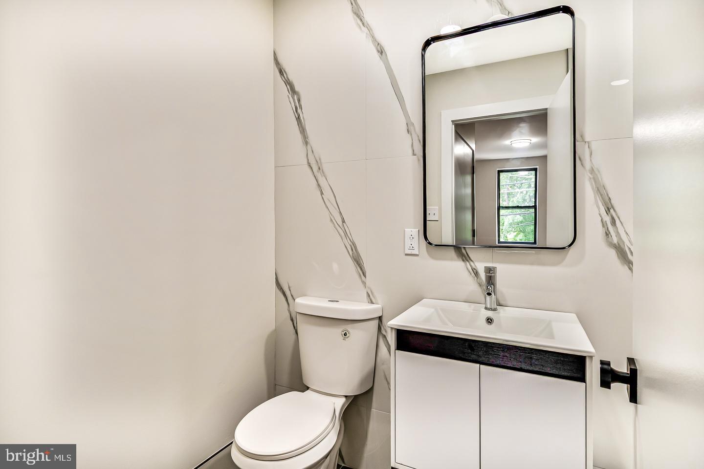 182 East Huntingdon Street Philadelphia, PA 19125 - Photo 26 of 41 a bathroom with a toilet sink and mirror