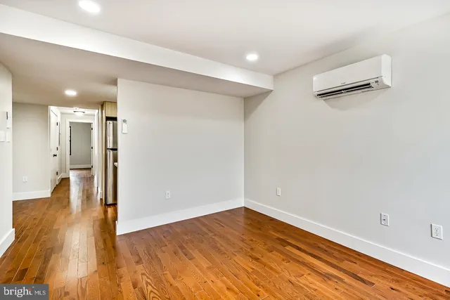 a view of a room with wooden floor and window