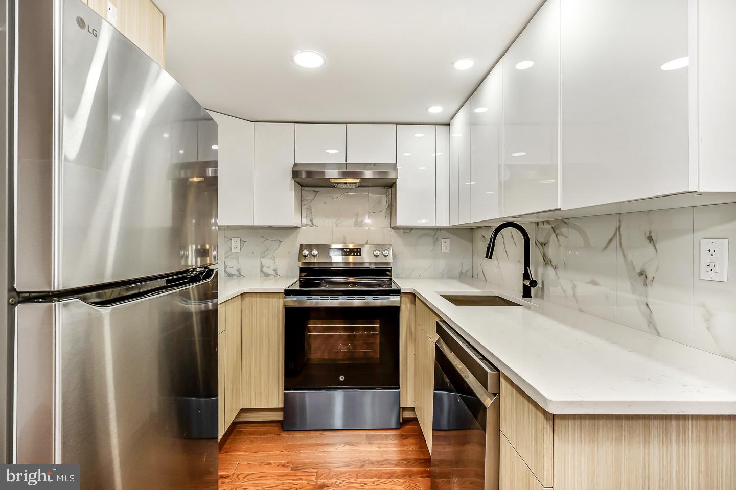 182 East Huntingdon Street Philadelphia, PA 19125 - Photo 31 of 41 a kitchen with a sink a refrigerator and cabinets