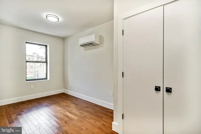 a view of a room with wooden floor