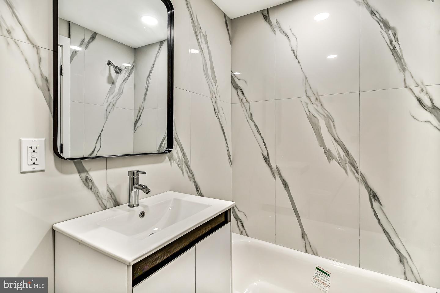182 East Huntingdon Street Philadelphia, PA 19125 - Photo 39 of 41 a bathroom with a sink and a mirror