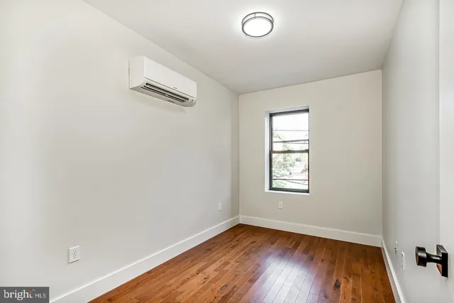 wooden floor in a hall with an empty room