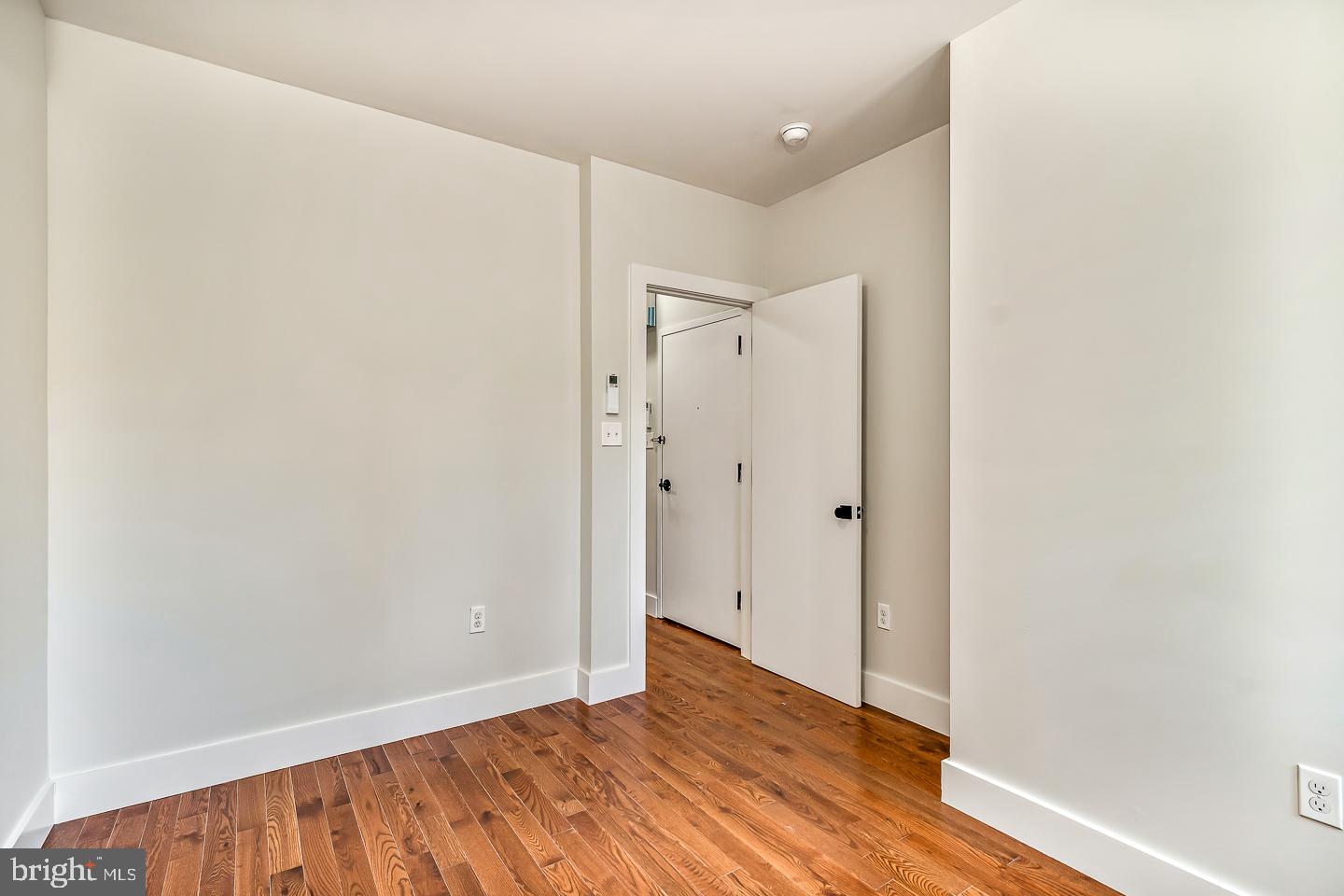 182 East Huntingdon Street Philadelphia, PA 19125 - Photo 7 of 41 a view of an empty room with wooden floor and a bathroom