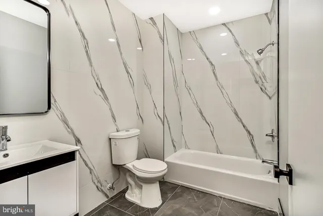 a bathroom with a toilet and a mirror