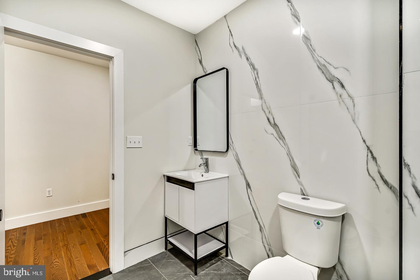 182 East Huntingdon Street Philadelphia, PA 19125 - Photo 9 of 41 a bathroom with a toilet and a mirror