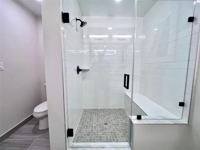 a bathroom with a shower and a toilet
