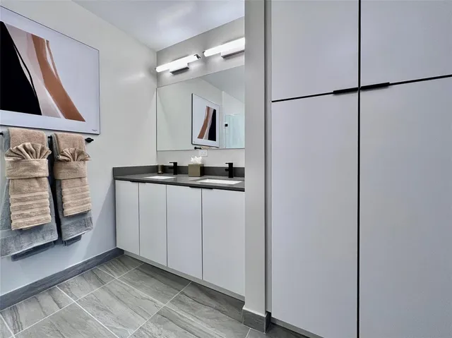 a bathroom with a mirror sink and vanity