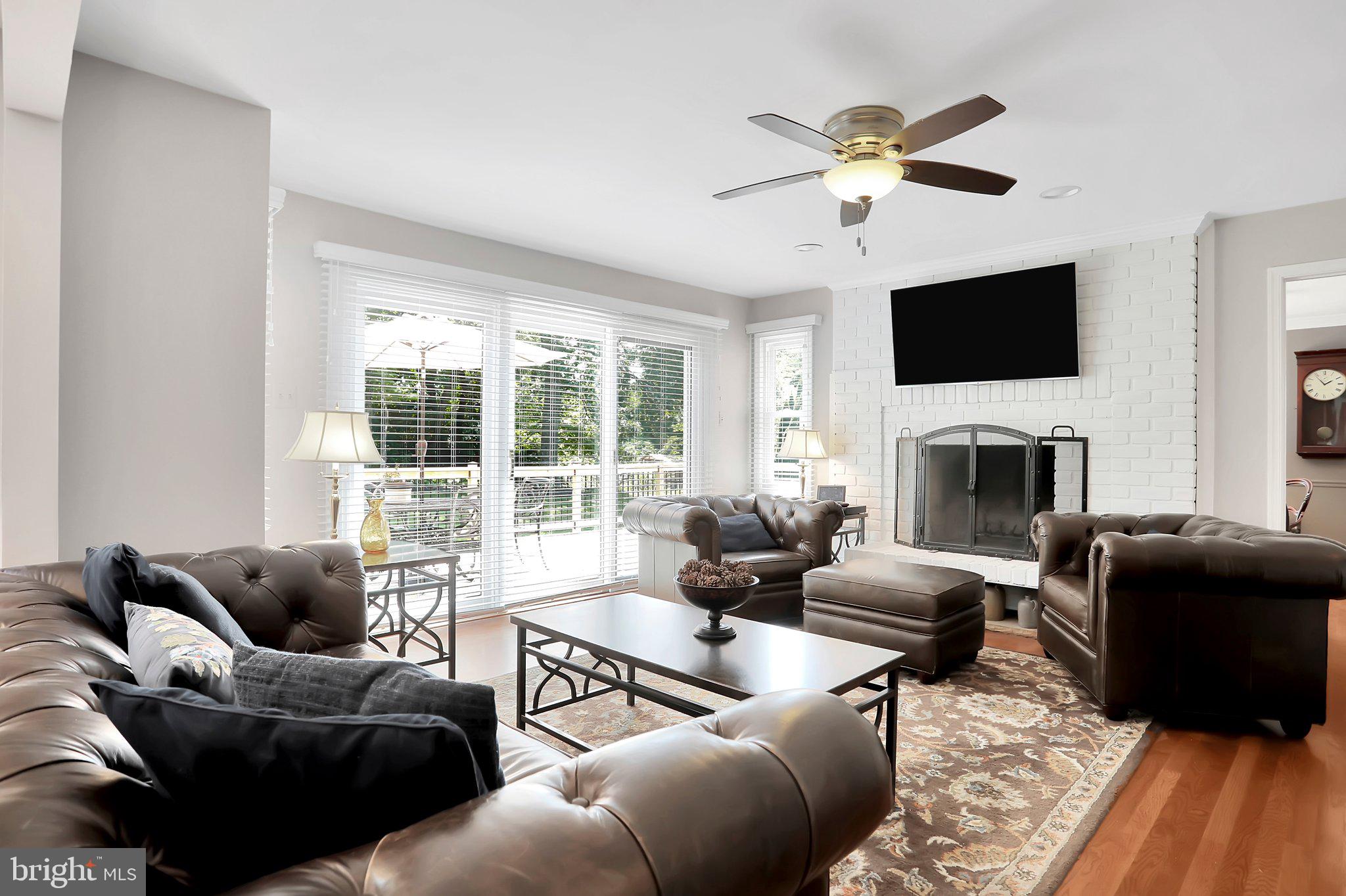 7845 Ridge Road Frederick, MD 21702 - Photo 18 of 67 a living room with furniture a flat screen tv and a fireplace