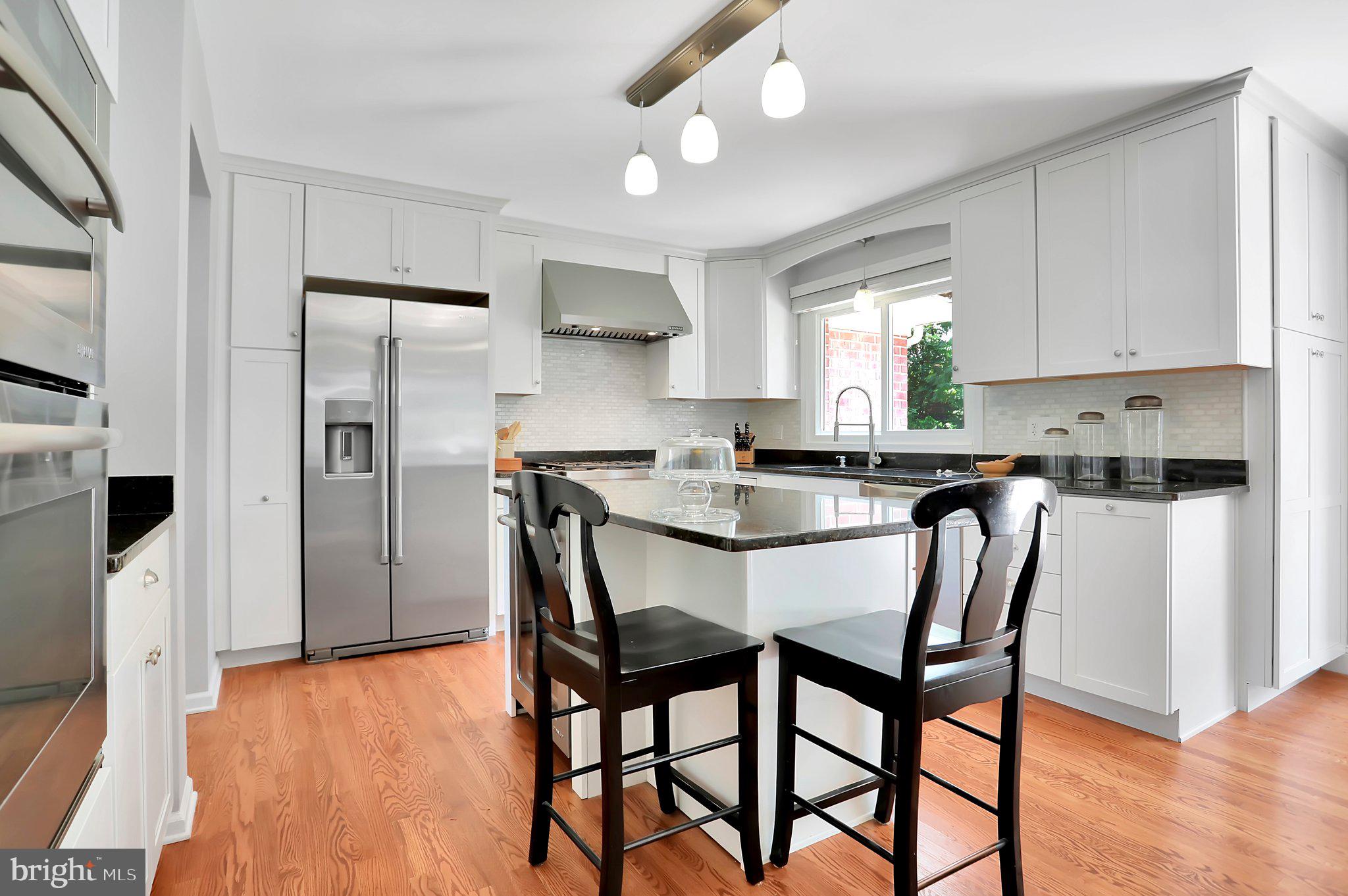 7845 Ridge Road Frederick, MD 21702 - Photo 22 of 67 a kitchen with stainless steel appliances granite countertop a dining table chairs refrigerator and microwave