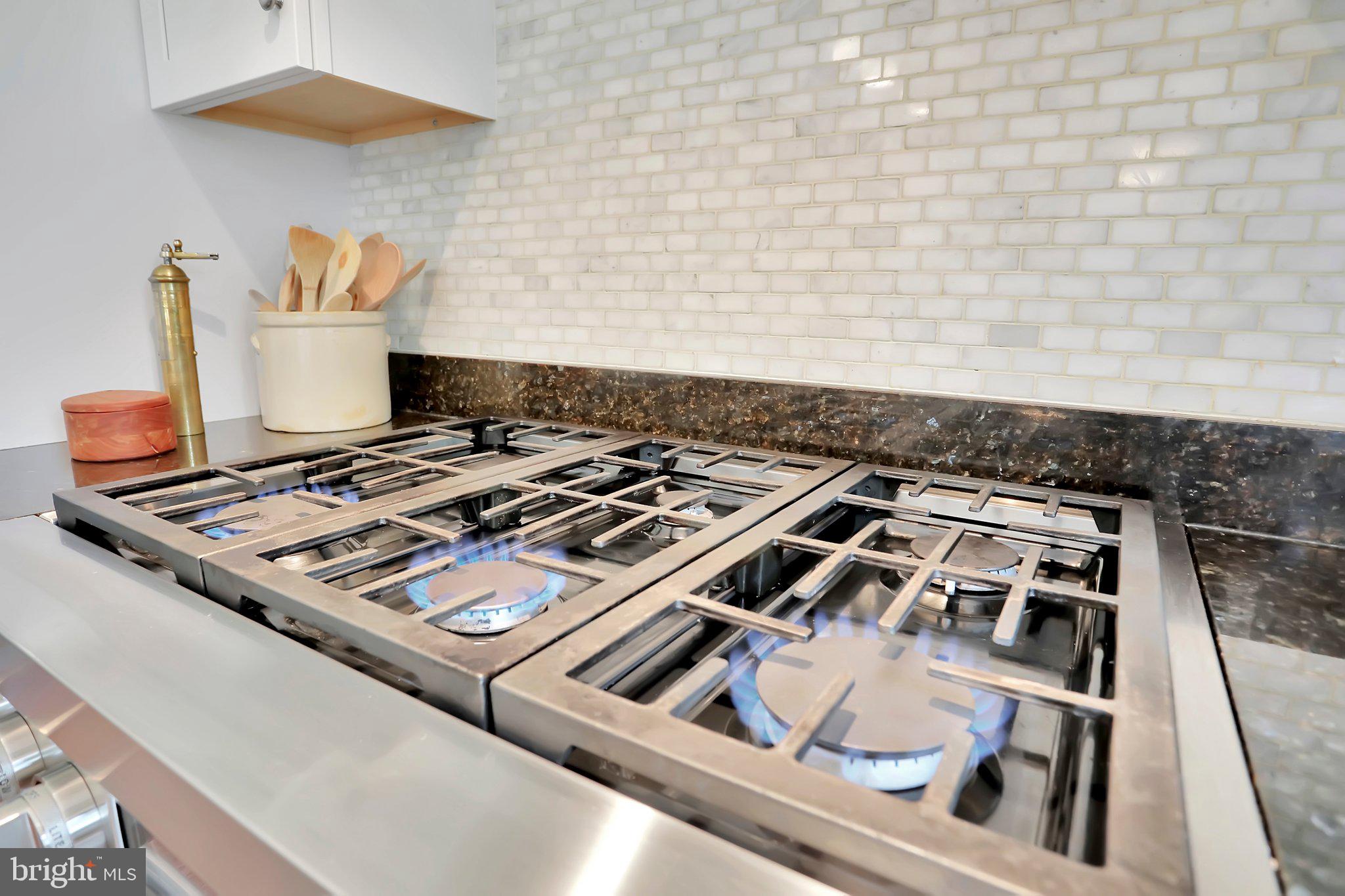 7845 Ridge Road Frederick, MD 21702 - Photo 23 of 67 a stove sitting inside of a kitchen with white cabinets