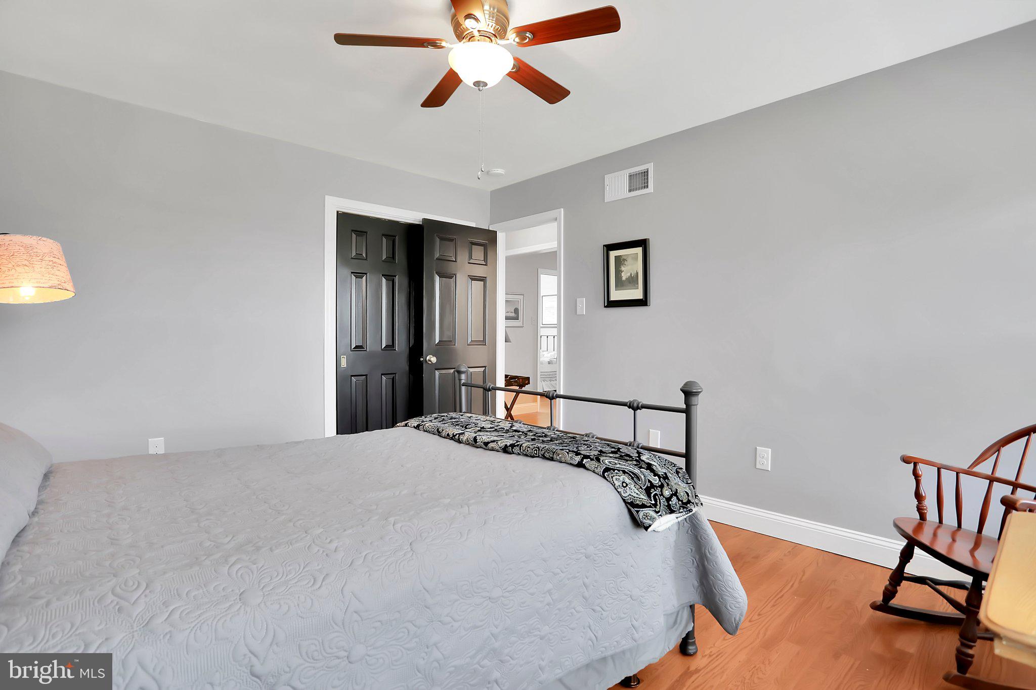 7845 Ridge Road Frederick, MD 21702 - Photo 31 of 67 a bedroom with a bed and a chandelier