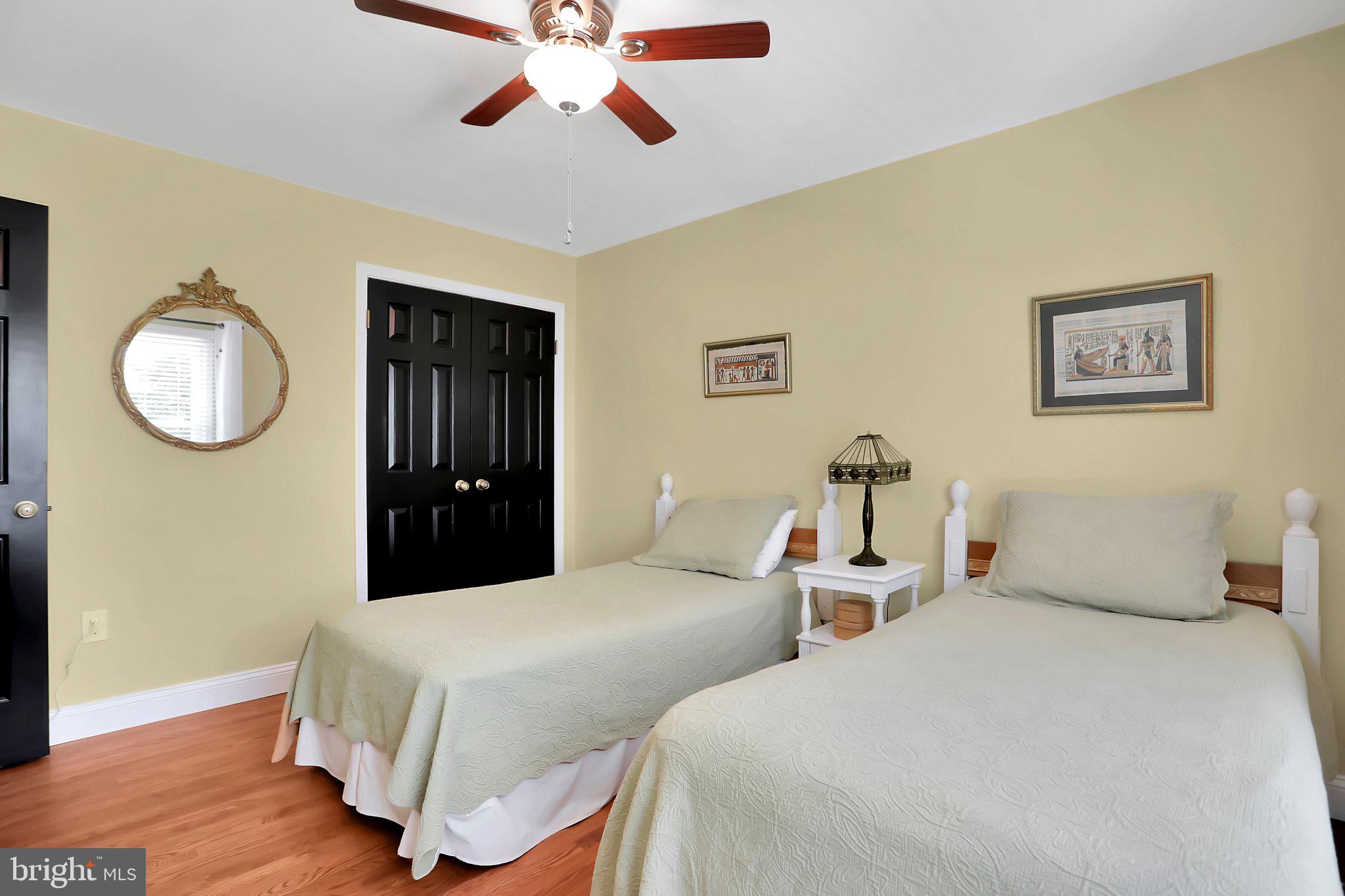 7845 Ridge Road Frederick, MD 21702 - Photo 35 of 67 a bedroom with two beds and a chandelier