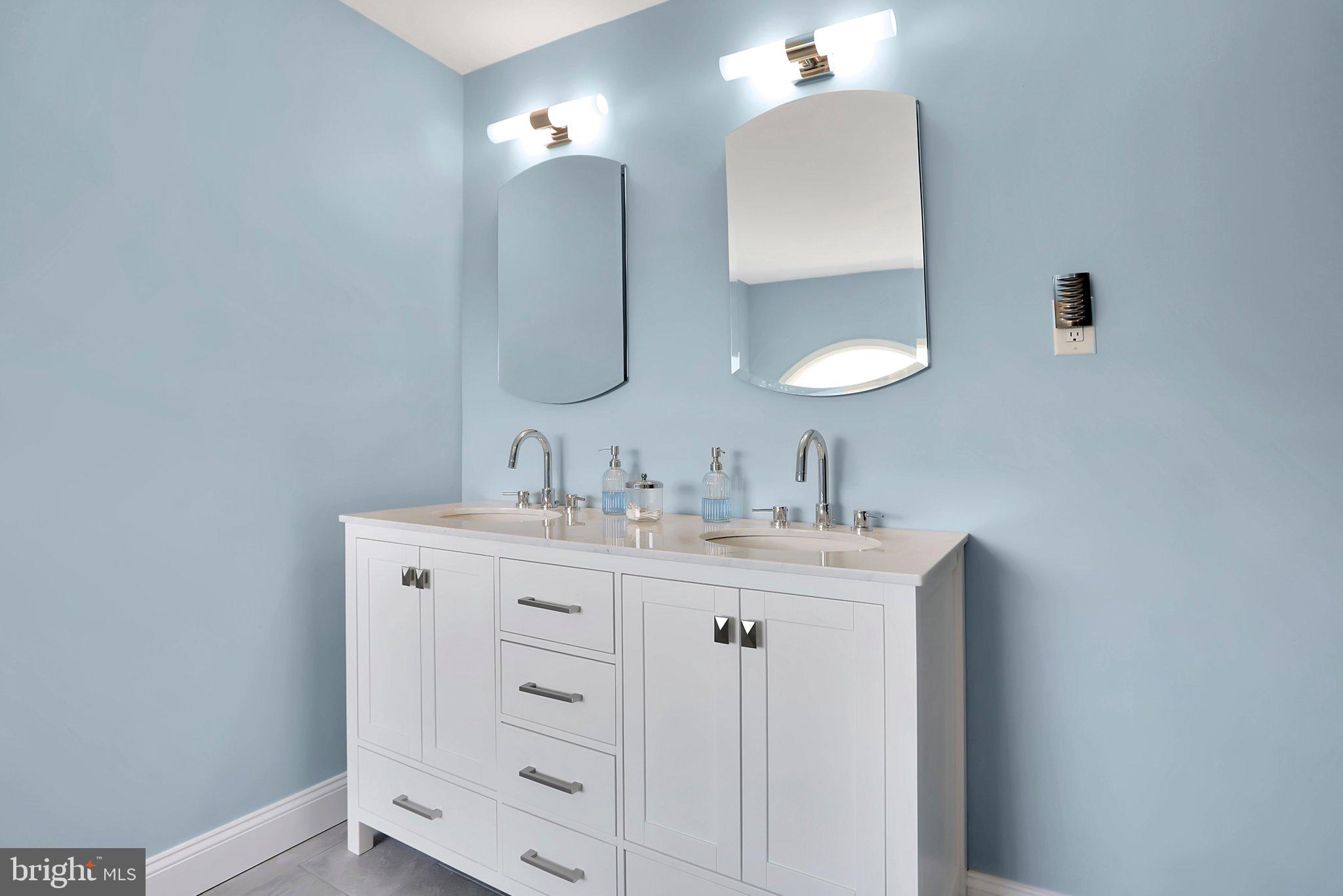 7845 Ridge Road Frederick, MD 21702 - Photo 43 of 67 a bathroom with a double vanity sink and a mirror