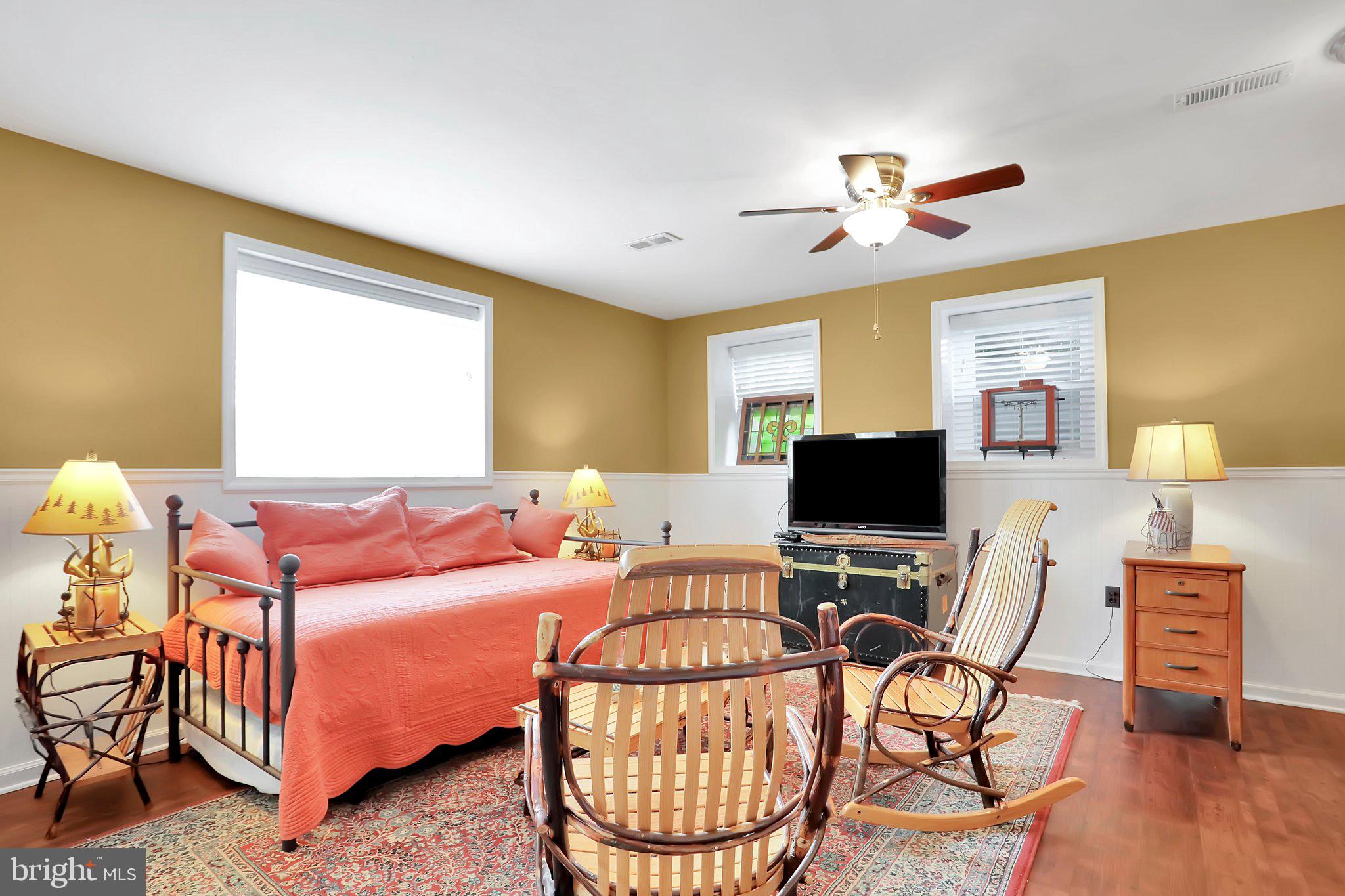 7845 Ridge Road Frederick, MD 21702 - Photo 48 of 67 a living room with furniture a flat screen tv and a window