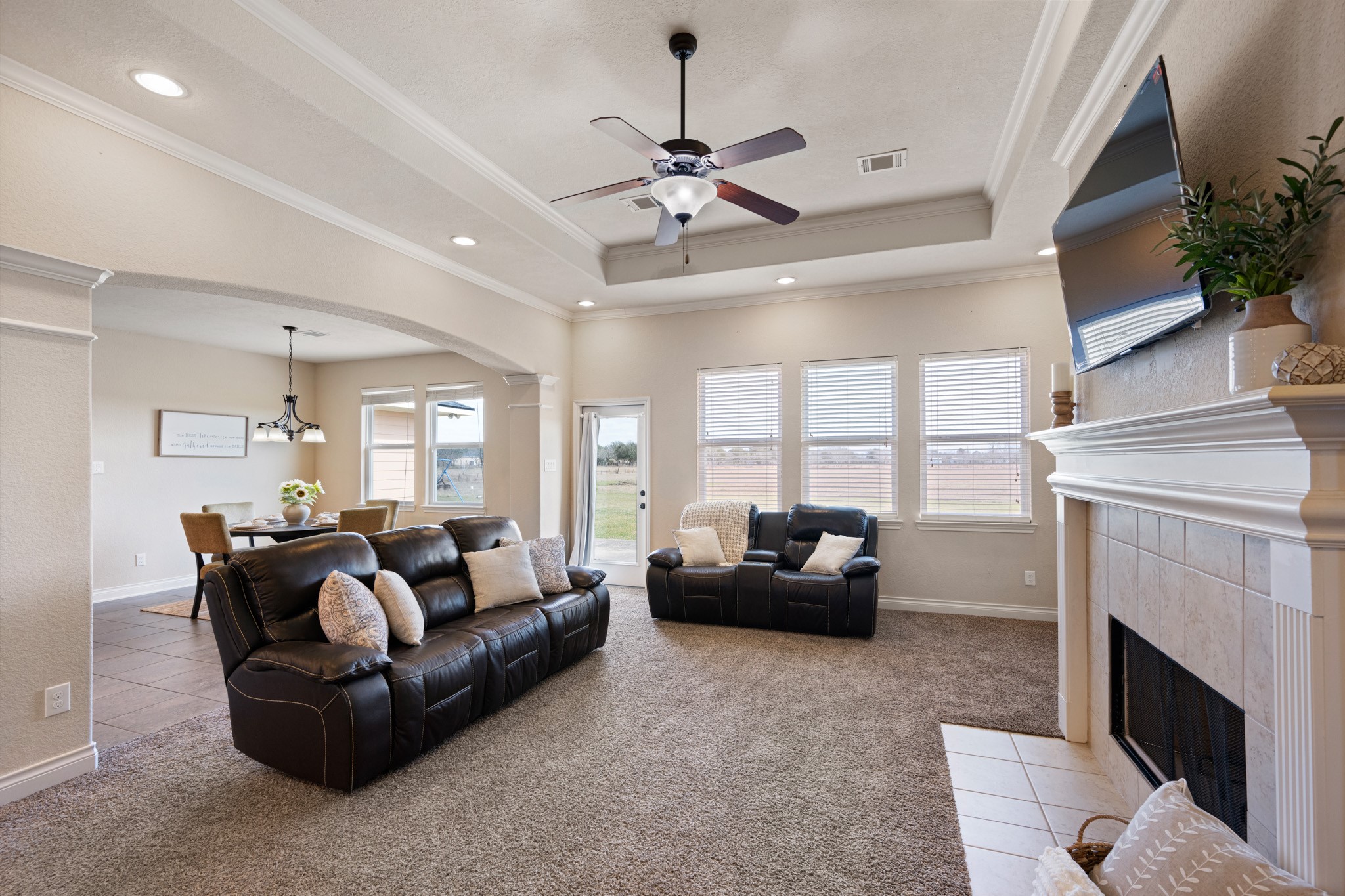 8131 Brinkmeyer Road Needville, TX 77461 - Photo 9 of 34 Living room is open to the dining area, creating a welcoming and functional space for relaxation and entertaining.