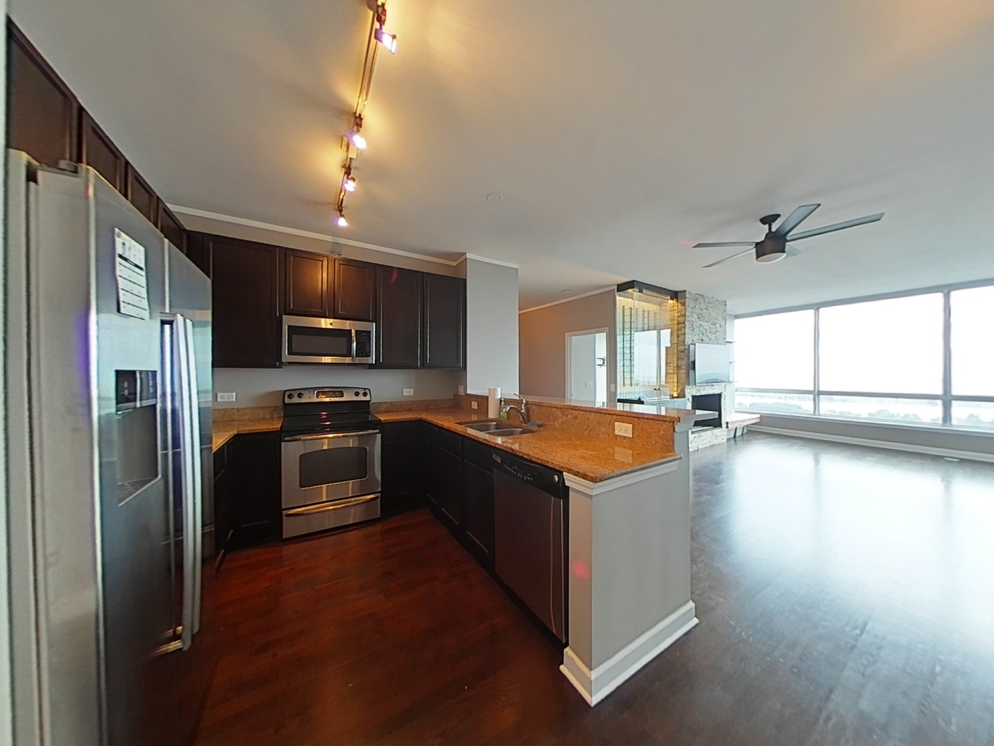1901 South Calumet Avenue, Unit 1405 Chicago, IL 60616 - Photo 5 of 20 a kitchen with stainless steel appliances granite countertop a refrigerator a sink dishwasher a stove and a oven with wooden floor