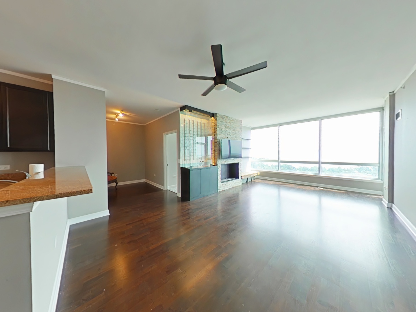 1901 South Calumet Avenue, Unit 1405 Chicago, IL 60616 - Photo 6 of 20 a view of a livingroom with wooden floor and a ceiling fan