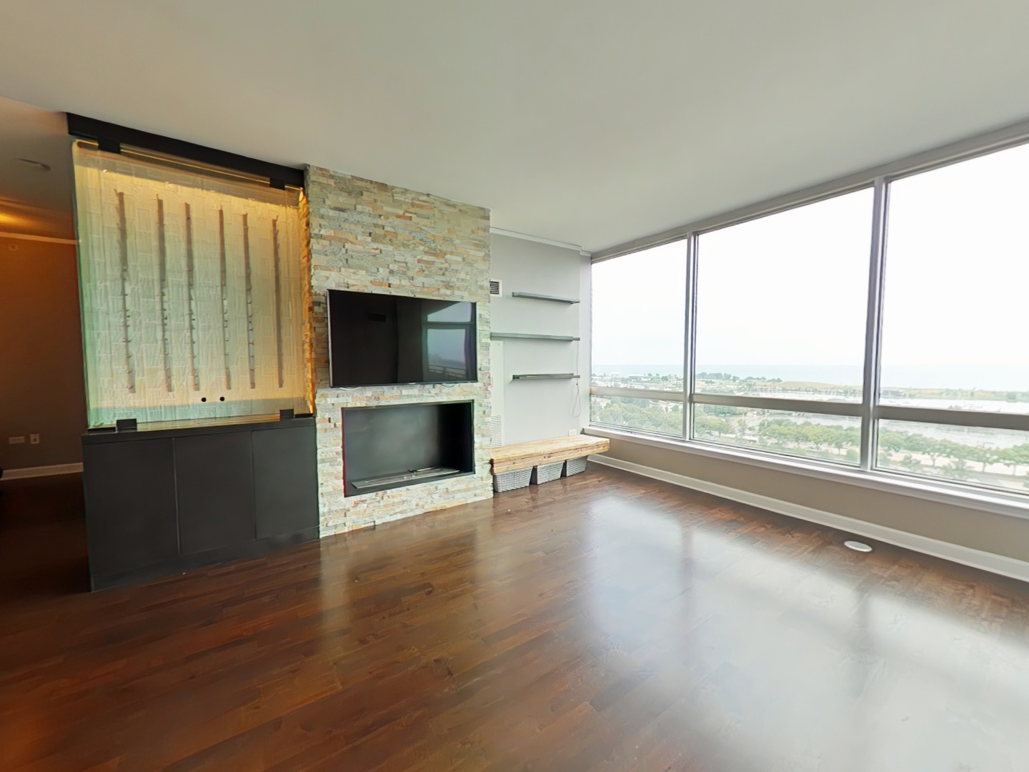 1901 South Calumet Avenue, Unit 1405 Chicago, IL 60616 - Photo 8 of 20 an empty room with wooden floor and windows