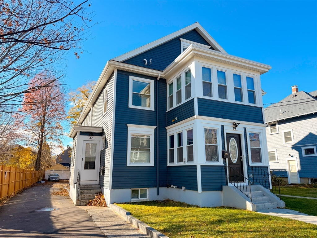39 Pond Street, Unit 2 Framingham, MA 01702 - Photo 2 of 18 a front view of a house with a yard